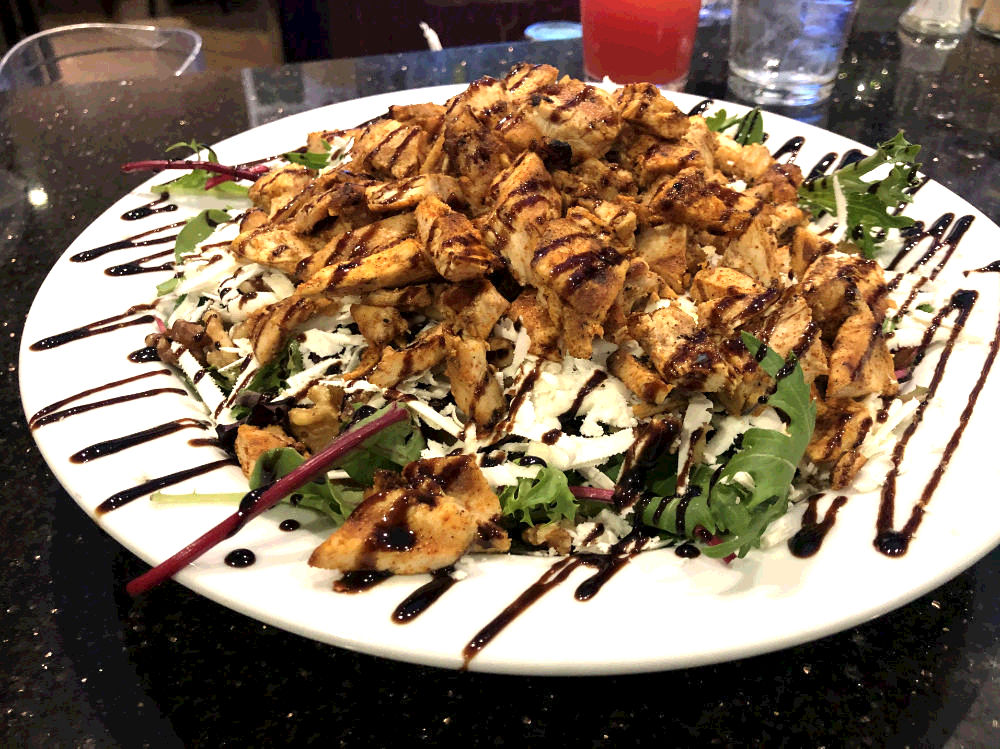 spring mix salad with grilled cajun chicken, feta and balsamic glaze